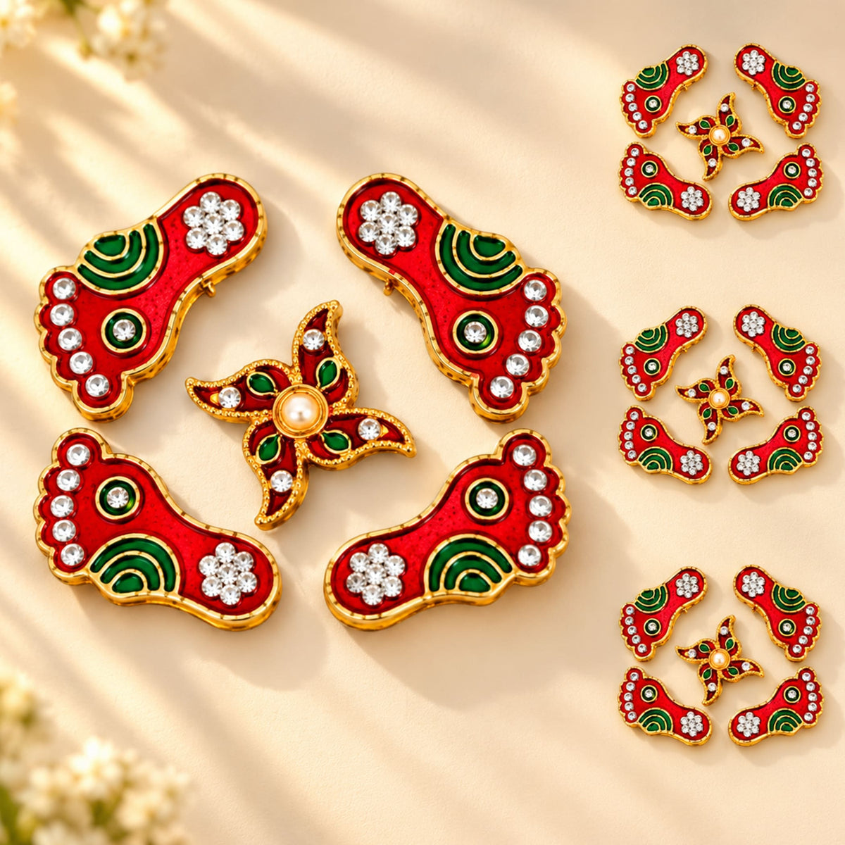 Metallic lakshmi charan paduka decorative pins in red and green with gold edges, rhinestones, and central pearl for pooja and home decor