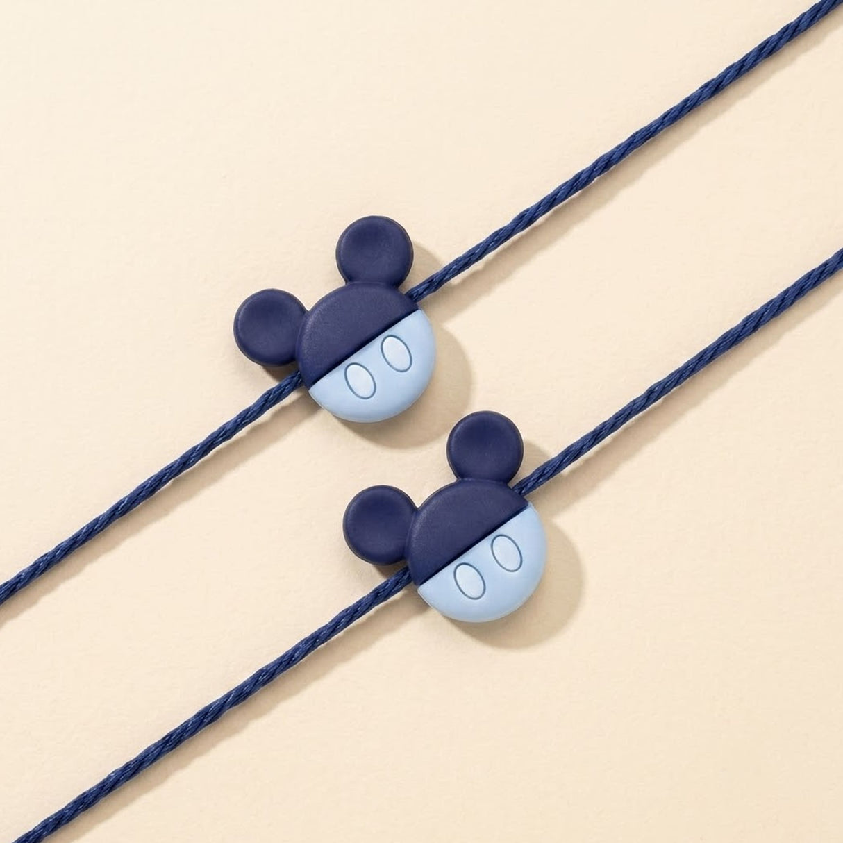 Mickey mouse rakhi for brother featuring navy and light blue silicone charms on braided cords for raksha bandhan gift