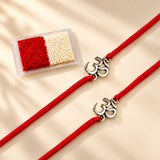 Two red cord rakhi bracelets with silver om symbol charms for bhai dooj gift hamper for brother rituals