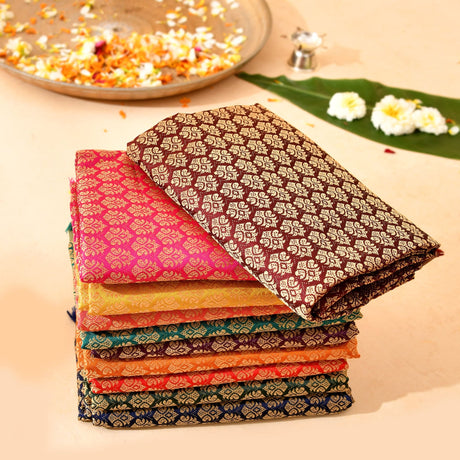 Stack of unstitched multicolor banarasi silk blouse pieces with intricate patterns for saree pooja and indian return gifts