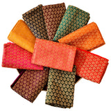 A collection of vibrant multicolor silk unstitched blouse pieces with intricate patterns for saree and Indian return gifts