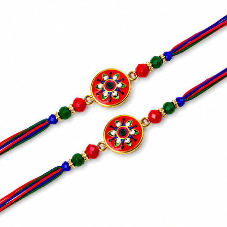 Handcrafted designer rakhi with vibrant red and gold enamel floral charm on multicolor braided thread bracelet