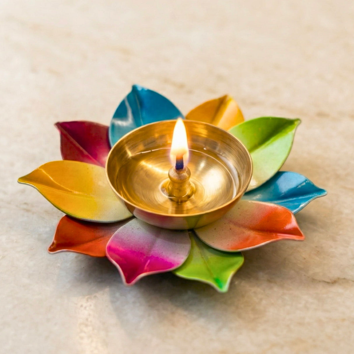 A golden brass oil lamp nestled in a vibrant multicolor lotus-shaped holder for indian puja and diwali decoration