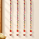 Four colorful pompom garland strings with red pompoms and gold bells for diwali and indian wedding decoration