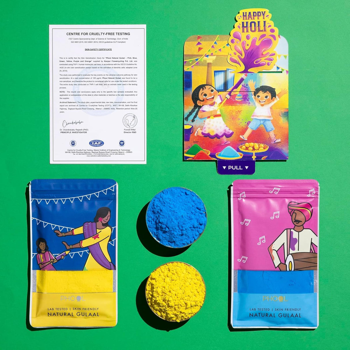 Vibrant yellow and red natural Holi gulal powder in festive packaging with greeting card