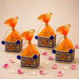 Pack of 4 blue and gold ornate small potli gift boxes with orange sheer organza bags and blue pom-poms for Indian festivals