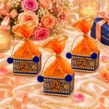 Pack of 4 small ornate blue and gold potli gift boxes with orange sheer organza and golden ganesha emblem for indian festivities