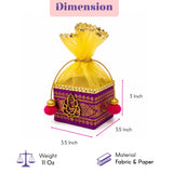 Purple fabric potli gift box with gold embroidery yellow sheer organza top and red pom-poms for indian weddings