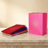 Vibrant pink paper om carry bag with gold symbol and twisted handles eco friendly for wedding puja gift giving