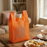 Bright orange reusable non woven tote bag with silver om print for Indian wedding party favors housewarming puja