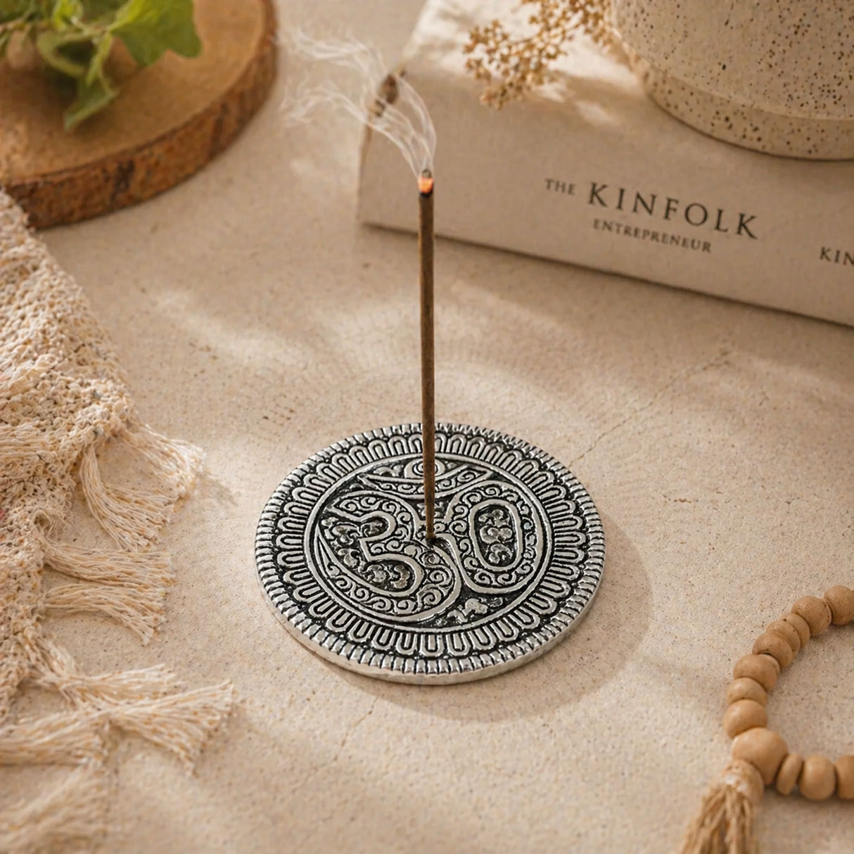 Silver-toned aluminum circular incense holder with intricate paisley mandala patterns and central om symbol for temple decor