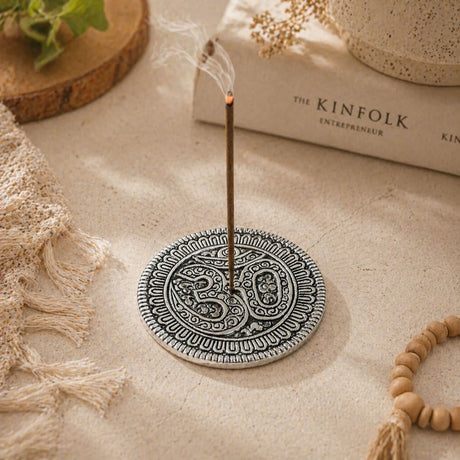 Silver-toned aluminum circular incense holder with intricate paisley mandala patterns and central om symbol for temple decor