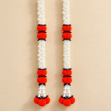 Two artificial jasmine marigold garlands featuring white flowers red pom-poms and black connectors for festive décor