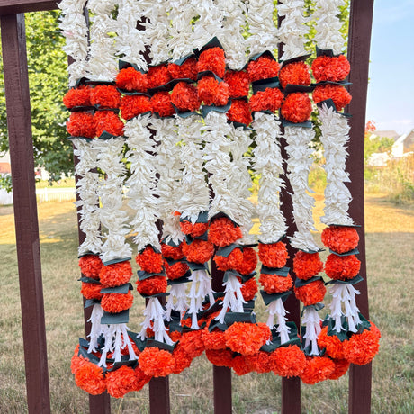White and orange artificial flower garlands for home decor and festive celebrations