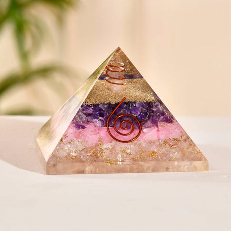 Orgonite pyramid with crystals and copper coils for chakra healing and spiritual energy