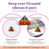 Orgonite pyramid with rainbow-colored resin and embedded golden chakra symbols for spiritual healing and meditation