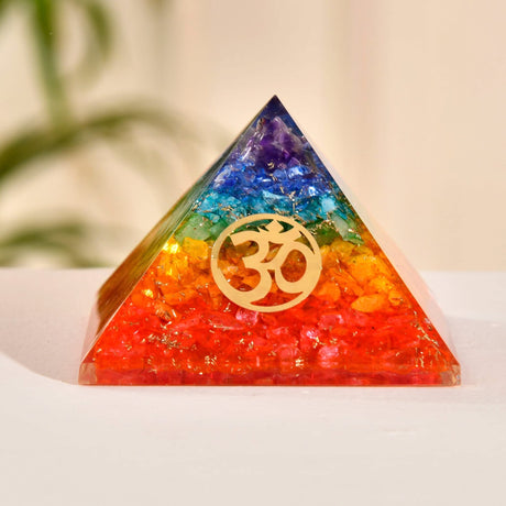 Rainbow-colored orgone pyramid with Om symbol for Chakra healing and spiritual energy