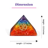 A vibrant rainbow-colored resin orgonite pyramid with a golden om symbol for chakra healing and spiritual energy