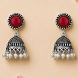 Silver oxidized floral jhumka earrings with red cabochon stone filigree and white faux pearls for traditional wear