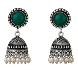 Silver oxidized floral jhumka earrings with green stone centerpiece clear crystals and faux pearl dangles for ethnic wear
