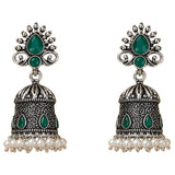 Silver oxidized floral jhumka earrings with intricate filigree, emerald teardrop stones, and faux pearl accents for ethnic wear