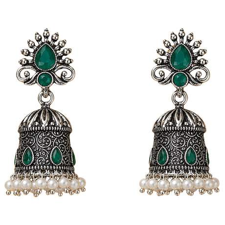 Silver oxidized floral jhumka earrings with intricate filigree, emerald teardrop stones, and faux pearl accents for ethnic wear