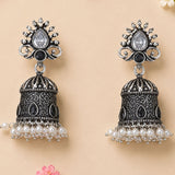 Silver and black ornate oxidized floral jhumka earrings with teardrop crystal and faux pearl dangles for ethnic wear