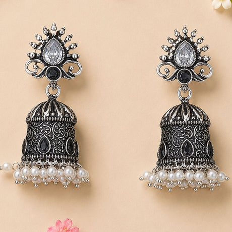 Silver and black ornate oxidized floral jhumka earrings with teardrop crystal and faux pearl dangles for ethnic wear