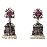Silver oxidized floral jhumka earrings with intricate filigree, fuchsia gemstones, and white faux pearls for ethnic wear