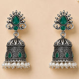 Silver oxidized floral jhumka earrings with intricate filigree emerald stones and white faux pearls for traditional wear