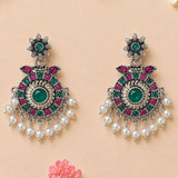 Silver oxidized floral chandbali earrings with emerald green stone, pink and teal gemstones, and white faux pearls for ethnic wear