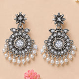Silver oxidized chandbali earrings with intricate floral design clear crystals and dangling white faux pearls for ethnic wear
