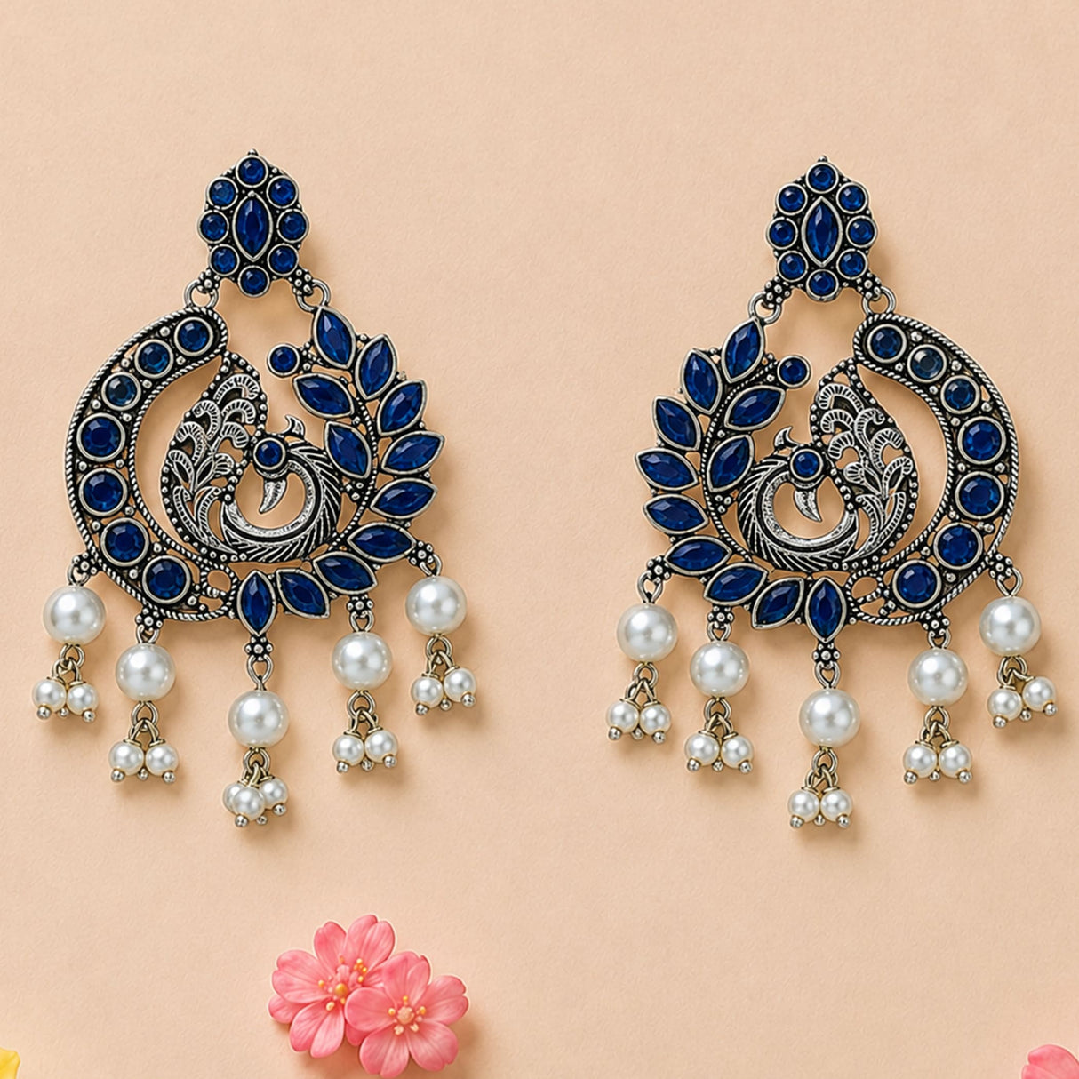 Elegant silver tone boho peacock chandbali earrings with deep blue stones and white pearl dangles for ethnic wear