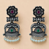 Silver oxidized elephant-themed jhumka earrings with floral tops, ruby emerald stones, and dangling faux pearl beads for women