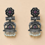Silver oxidized floral jhumka earrings with intricate elephant designs purple gemstones and faux pearl dangles for festive wear