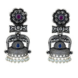 Indian oxidized silver jhumka earrings with intricate floral elephant designs, purple and blue stones, and faux pearl dangles