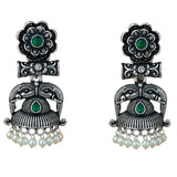 Silver oxidized floral jhumka earrings with green gemstone accents and pearl drops for diwali and ethnic wear