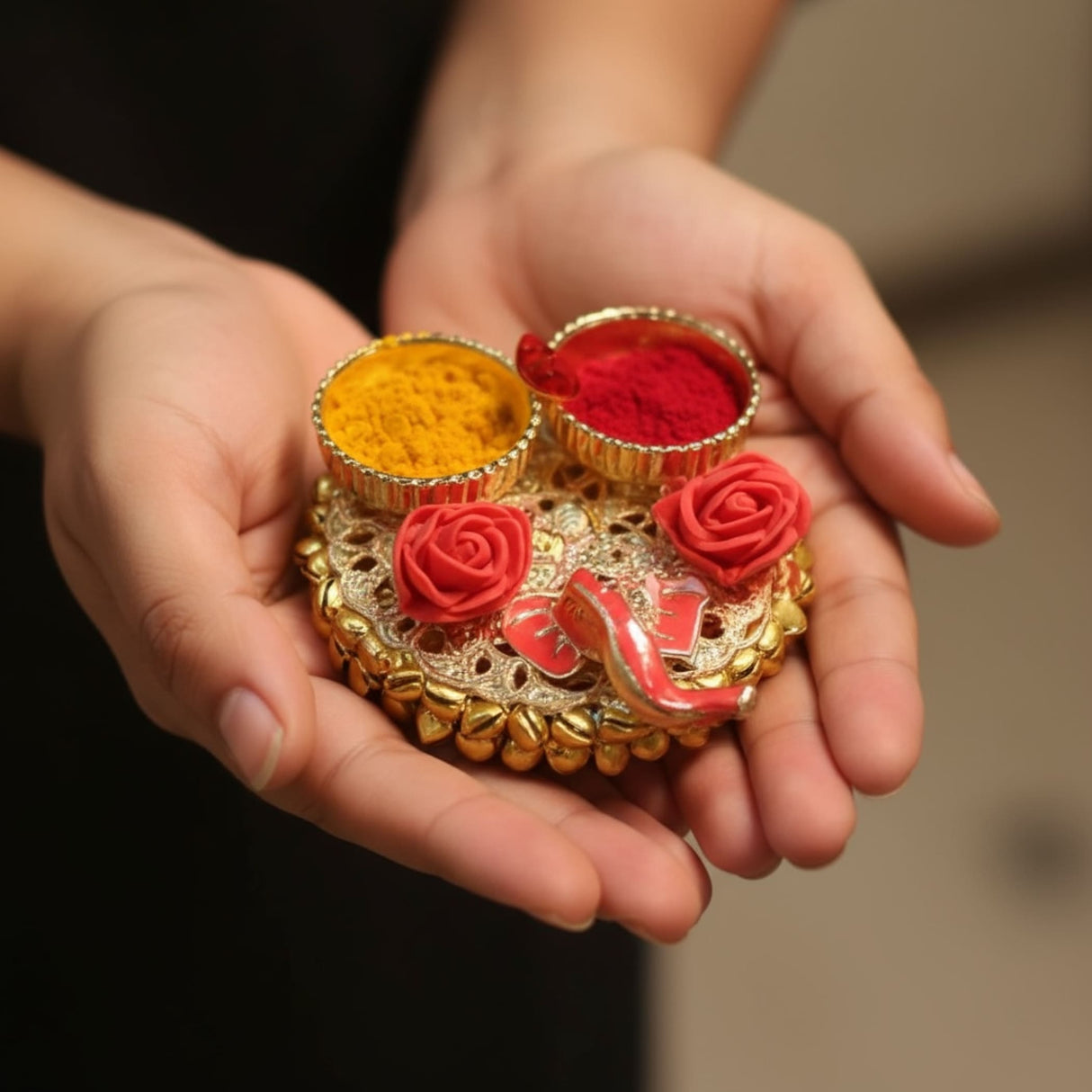Golden rose-adorned trinket box with vibrant red and yellow powders for Pooja and Indian gifts
