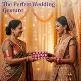 Vibrant magenta brocade shagun envelope with gold paisley, held by women in Indian wedding attire