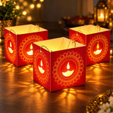 Red paper lantern boxes with golden mandala designs and glowing diyas for diwali decorations and table centerpieces