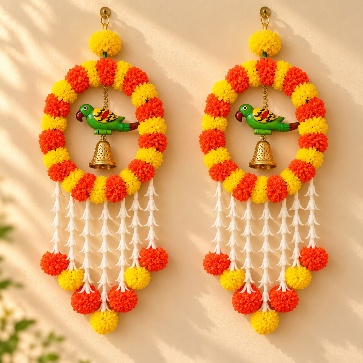 Vibrant orange and yellow artificial marigold pom-pom wreath with green parrot figurine and white tassels for festive decor
