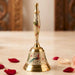 Decorative peacock temple bell made of brass with intricate hand-painted red green and gold floral designs for pooja