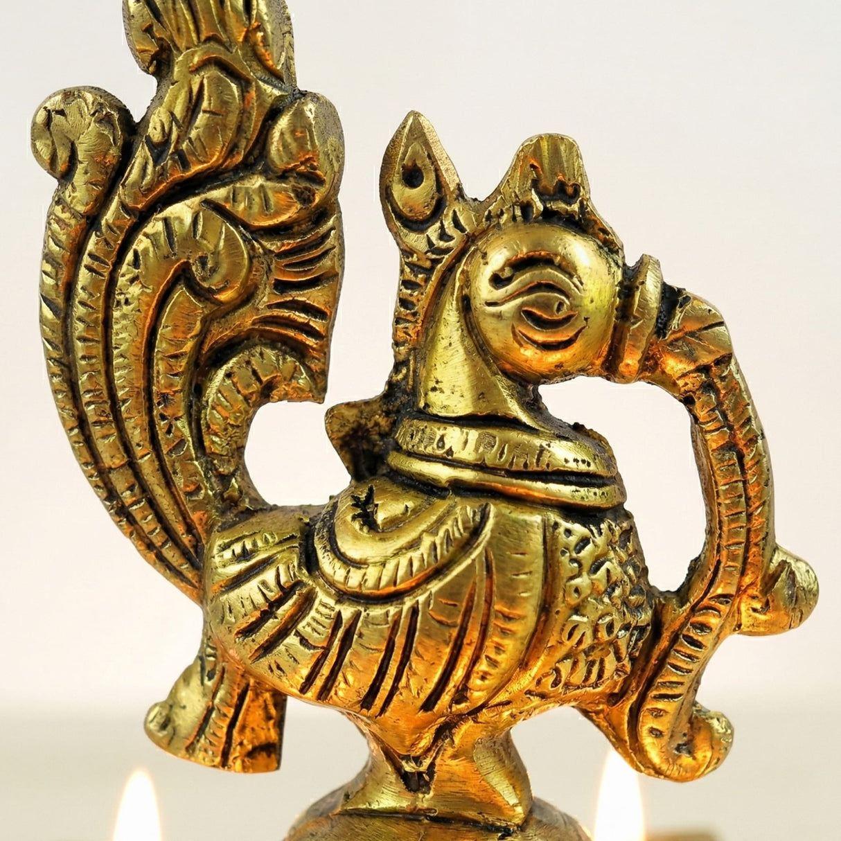 Golden brass finish peacock deepam diya oil lamp with ornate carvings for Diwali puja and Indian home decor