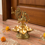 Golden brass peacock deepam diya with five lit oil lamps for diwali puja home decor and festive occasions