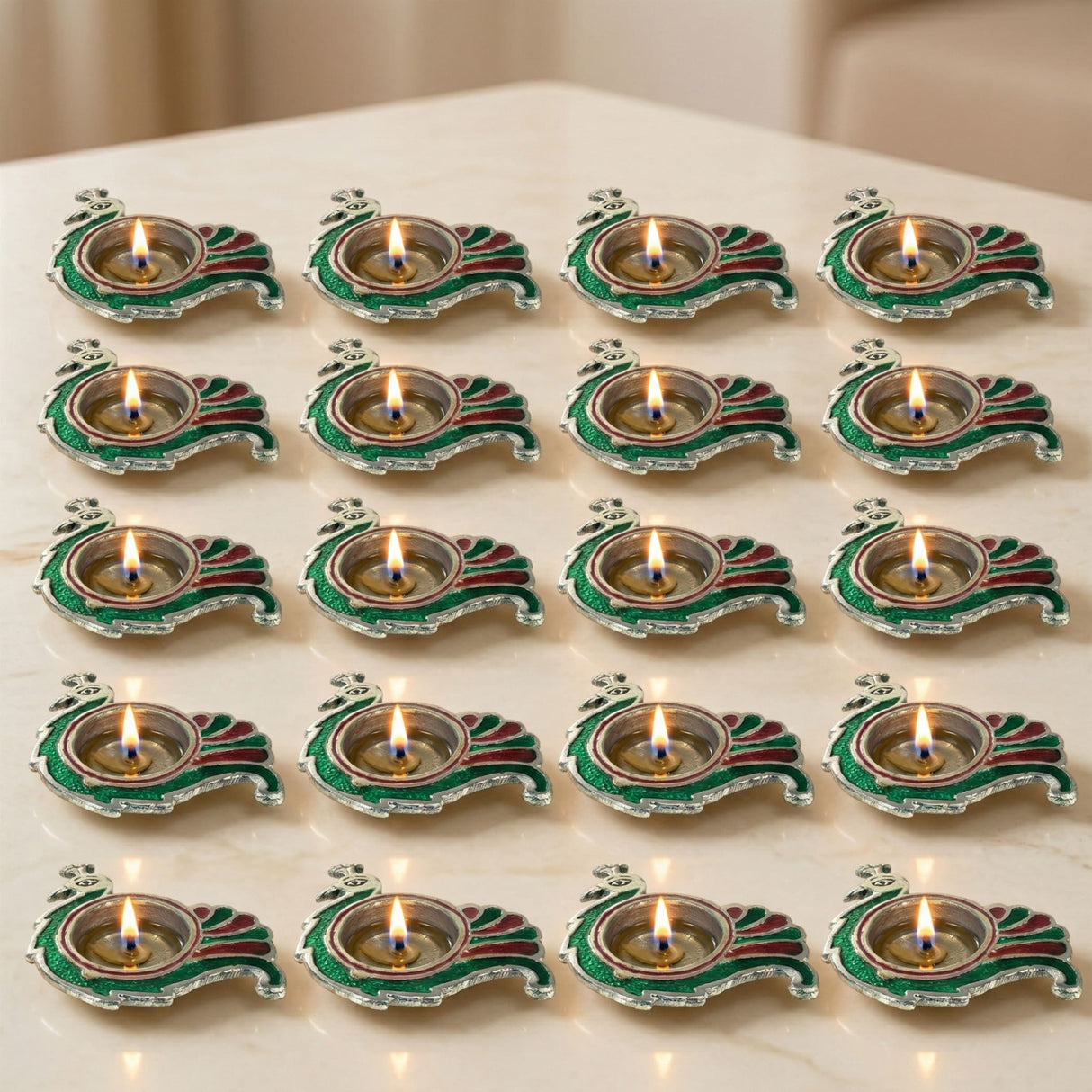 Green and red enamel peacock-shaped brass finish diya oil lamps with silver trim for diwali pooja and home decor