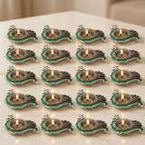 Green and red enamel peacock-shaped brass finish diya oil lamps with silver trim for diwali pooja and home decor