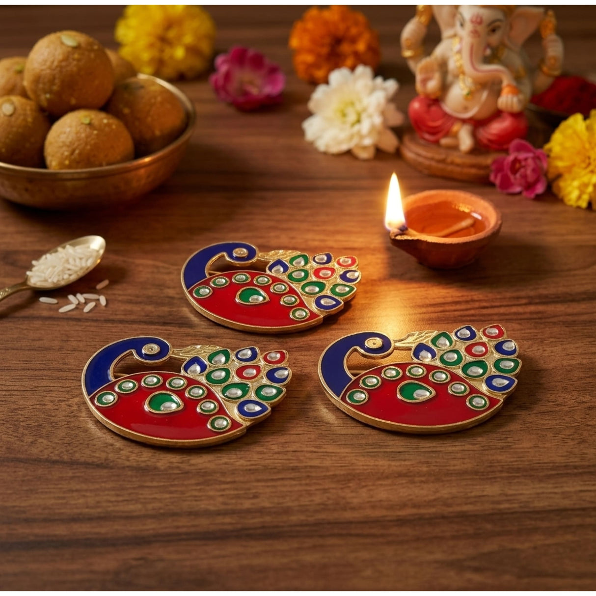 Vibrant red and blue peacock-shaped decorative bulk haldi kumkum diya holders with green white and gold enamel detailing for diwali pooja
