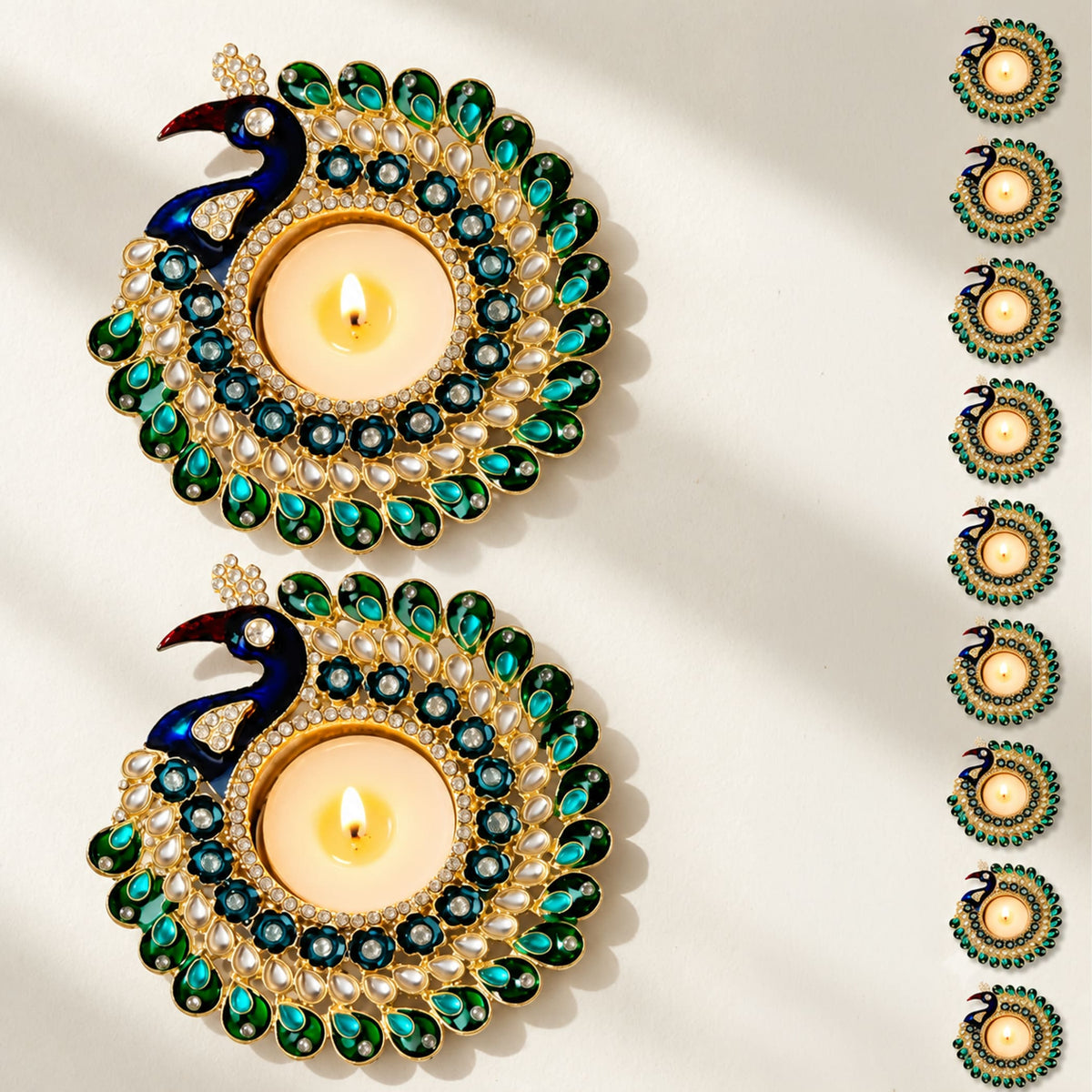 Golden peacock-themed tealight holder adorned with green blue gemstones white pearls and rhinestones for diwali pooja decor