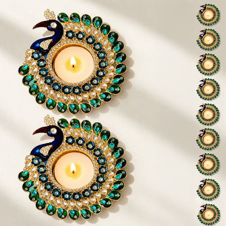 Golden peacock-themed tealight holder adorned with green blue gemstones white pearls and rhinestones for diwali pooja decor