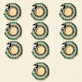 Set of nine ornate peacock tealight candle holders with black and blue heads and crystal-adorned green tails for decor